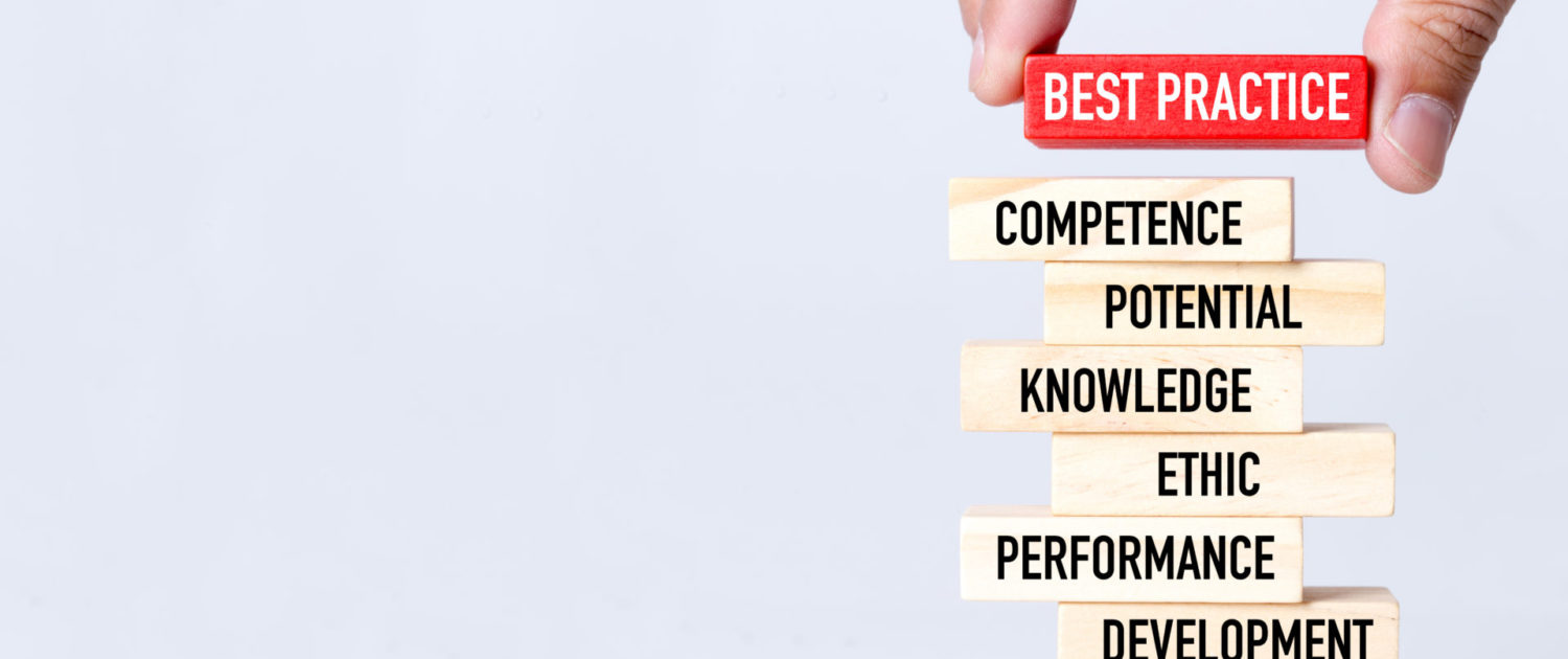 Businessman Building BEST PRACTICE Concept with Wooden Blocks